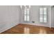 Elegant dining room featuring hardwood floors, classic paneling, and shuttered windows at 3320 Woodleaf Way, Marietta, GA 30062