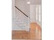 Bright entryway features hardwood floors and a staircase with white banister at 3320 Woodleaf Way, Marietta, GA 30062