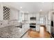 Updated kitchen boasts granite countertops, stainless steel appliances, and custom cabinets at 3320 Woodleaf Way, Marietta, GA 30062