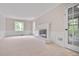 Bright living room features a fireplace, large windows, and neutral carpet at 3320 Woodleaf Way, Marietta, GA 30062