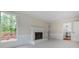 Cozy living room featuring a fireplace, large windows, and access to the deck at 3320 Woodleaf Way, Marietta, GA 30062