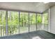 Screened-in porch offering views of the backyard with lush greenery at 3320 Woodleaf Way, Marietta, GA 30062