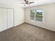 Bright bedroom featuring a ceiling fan, closet and window at 6105 Ivey Hill Dr, Cumming, GA 30040