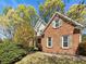 Charming brick home featuring green shutters, mature landscaping, and a well-maintained lawn at 6105 Ivey Hill Dr, Cumming, GA 30040