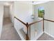 Carpeted hallway with white railing and an arched window at 6105 Ivey Hill Dr, Cumming, GA 30040