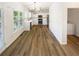 Bright kitchen features white cabinets, modern appliances, dark hardware, and wood flooring at 6105 Ivey Hill Dr, Cumming, GA 30040