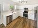 Modern kitchen features white cabinets, stainless steel appliances, and sleek countertops at 6105 Ivey Hill Dr, Cumming, GA 30040