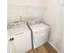 Well-lit laundry room with washer, dryer, and wire shelving for convenient and organized chores at 6105 Ivey Hill Dr, Cumming, GA 30040