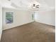 Spacious main bedroom featuring a tray ceiling, neutral color palette, and carpeted floors at 6105 Ivey Hill Dr, Cumming, GA 30040