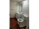 Standard bathroom with toilet, sink and vanity, and wood-look flooring at 921 Eagle Crossing Dr, Lawrenceville, GA 30044