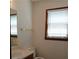 Bathroom featuring a single sink vanity with a framed mirror, natural light, and neutral walls at 921 Eagle Crossing Dr, Lawrenceville, GA 30044