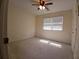 Bedroom showcases neutral carpet, a ceiling fan, and window for natural light at 921 Eagle Crossing Dr, Lawrenceville, GA 30044