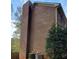 Exterior shot of brick home featuring chimney and HVAC unit at 921 Eagle Crossing Dr, Lawrenceville, GA 30044