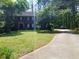 Traditional two-story brick home with a manicured lawn and long driveway at 921 Eagle Crossing Dr, Lawrenceville, GA 30044