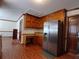 Kitchen with stainless steel refrigerator, granite counters, and dark wood cabinets at 921 Eagle Crossing Dr, Lawrenceville, GA 30044