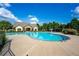 Large community pool with lounge chairs and shade structures on a sunny day at 2060 Executive Dr, Duluth, GA 30096