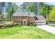Traditional brick home with meticulously kept lawn, 2-car garage, and lush landscaping at 2830 Scottish Mill Way, Marietta, GA 30068