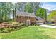 Charming brick home featuring a manicured lawn, black shutters, and an attached two car garage at 2830 Scottish Mill Way, Marietta, GA 30068