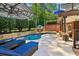 Backyard oasis with a pool, hot tub, and lounge chairs, perfect for relaxation and entertainment at 3115 Corsair Curv, Cumming, GA 30040