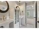 Bathroom featuring dual sinks, modern fixtures, framed mirrors, and black and white patterned tile at 3115 Corsair Curv, Cumming, GA 30040