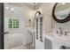 Well-lit bathroom with double sinks, stylish mirrors, and modern fixtures at 3115 Corsair Curv, Cumming, GA 30040
