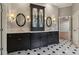 Bathroom with a vanity with dual sinks, dark cabinets, tile flooring, and decorative lighting at 3115 Corsair Curv, Cumming, GA 30040