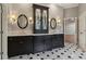 Bathroom featuring black cabinets, a decorative tile floor, and a double vanity with marble countertop at 3115 Corsair Curv, Cumming, GA 30040
