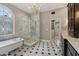 Luxurious bathroom featuring a clawfoot tub, tiled shower, and black and white checkered flooring at 3115 Corsair Curv, Cumming, GA 30040