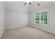 Bright bedroom featuring a large window, plush carpet and neutral finishes at 3115 Corsair Curv, Cumming, GA 30040