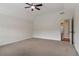 This spacious bedroom features plush carpeting, ceiling fan, and neutral walls at 3115 Corsair Curv, Cumming, GA 30040