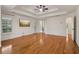 Spacious primary bedroom with natural light, hardwood floors, tray ceiling and an en-suite bathroom at 3115 Corsair Curv, Cumming, GA 30040