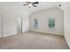 Bright bedroom with neutral carpet, two windows with backyard views, and a ceiling fan at 3115 Corsair Curv, Cumming, GA 30040