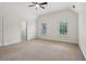 Bedroom with neutral carpet, a ceiling fan, two windows with plantation shutters, and white walls at 3115 Corsair Curv, Cumming, GA 30040