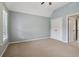 Spacious bedroom with neutral carpet, light blue walls, and a vaulted ceiling at 3115 Corsair Curv, Cumming, GA 30040