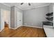 This bedroom features sleek hardwood floors, a ceiling fan, and custom built-in shelves with desk at 3115 Corsair Curv, Cumming, GA 30040