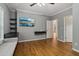 Bedroom with wood floors, ceiling fan, built-in shelves, desk area and a mounted TV at 3115 Corsair Curv, Cumming, GA 30040