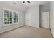 Bedroom with large windows, plantation shutters, and neutral carpet at 3115 Corsair Curv, Cumming, GA 30040