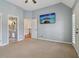 Cozy bedroom featuring neutral carpet, light-colored walls, ceiling fan, and a TV for a modern living experience at 3115 Corsair Curv, Cumming, GA 30040