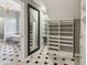 Spacious walk-in closet with custom shelving and a full-length mirror with marble floors at 3115 Corsair Curv, Cumming, GA 30040
