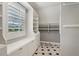 Bright walk-in closet with window, showcasing built-in shelving and ample storage space at 3115 Corsair Curv, Cumming, GA 30040