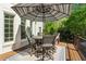 Outdoor deck features a dining set under a striped umbrella, perfect for entertaining at 3115 Corsair Curv, Cumming, GA 30040