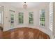 Dining nook with a view to the trees, hardwood floors, large windows and plantation shutters at 3115 Corsair Curv, Cumming, GA 30040