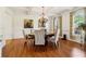 Charming dining room with hardwood floors, chandelier, and large windows at 3115 Corsair Curv, Cumming, GA 30040
