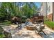Stone patio with a charming stone fire pit and seating; perfect for outdoor entertaining at 3115 Corsair Curv, Cumming, GA 30040