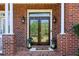 Elegant front entryway with ornate glass doors, decorative lanterns, and brick pillars, creating a grand entrance at 3115 Corsair Curv, Cumming, GA 30040