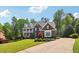 Attractive brick home with a double porch, well-manicured lawn, and landscaping for great curb appeal at 3115 Corsair Curv, Cumming, GA 30040