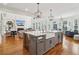 Spacious kitchen with large island and sink, stainless fridge, and views to the living room at 3115 Corsair Curv, Cumming, GA 30040
