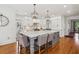 Bright kitchen with stainless steel appliances, a large island, and lantern-style pendant lighting at 3115 Corsair Curv, Cumming, GA 30040