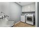 This functional laundry area features washer, dryer and cabinets for ample storage at 3115 Corsair Curv, Cumming, GA 30040