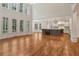 Bright living room with large windows, hardwood floors, and seamless flow to the kitchen at 3115 Corsair Curv, Cumming, GA 30040